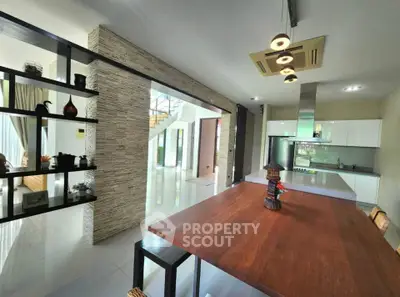 Spacious modern kitchen with open layout and elegant dining area in luxury home.
