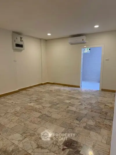 Spacious unfurnished room with marble flooring and air conditioning, ideal for customization.