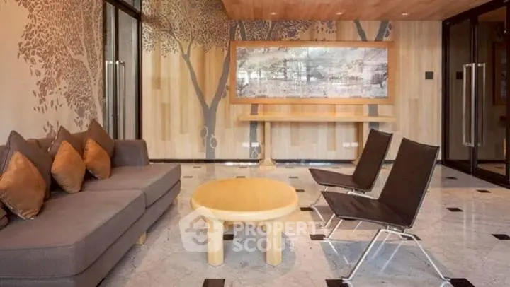 Elegant modern living room with stylish furniture and artistic wall design, perfect for relaxation.