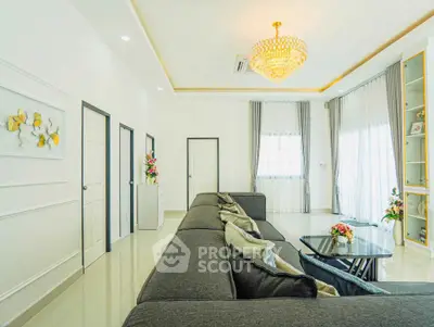 Luxurious living room with elegant chandelier and large windows