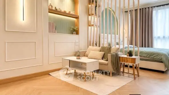 Modern open-plan living room with stylish decor and cozy bedroom area.