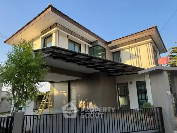 Modern two-story house with sleek design and spacious driveway, perfect for contemporary living.