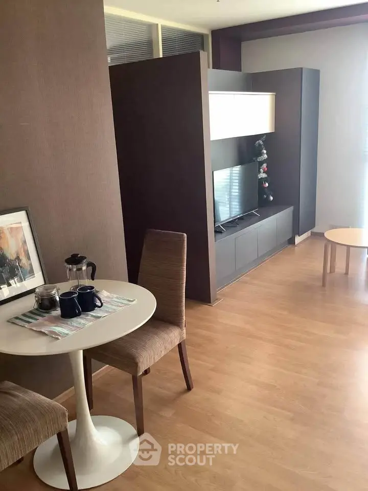 Modern living room with stylish furniture and wooden flooring, perfect for cozy urban living.