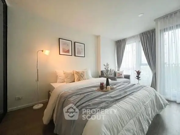 Elegant bedroom with cozy decor and natural light, featuring a stylish bed and modern furnishings.