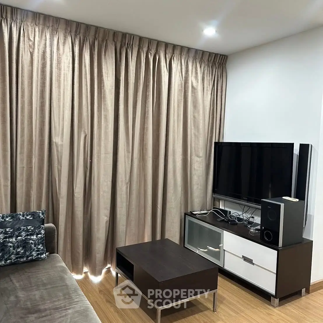 Modern living room with sleek furniture and large curtains, perfect for cozy evenings.