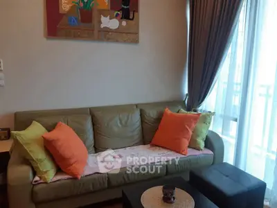 Cozy living room with stylish sofa and vibrant cushions, perfect for relaxation and comfort.