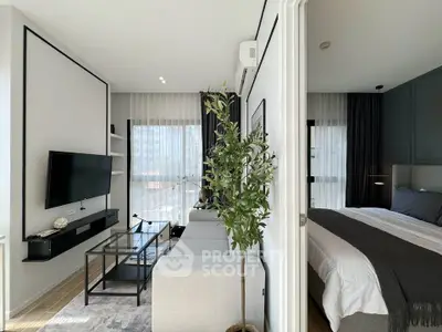 Modern living room with sleek decor and adjoining bedroom in a stylish apartment.