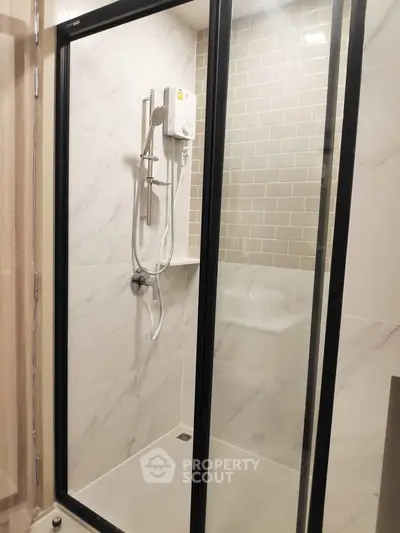 Modern bathroom with sleek shower enclosure and elegant tile design