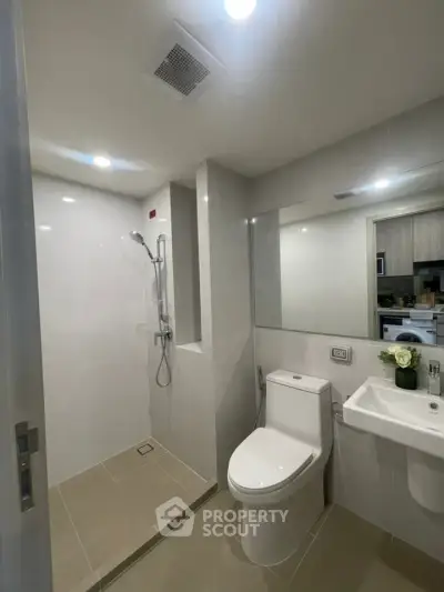 Modern bathroom with sleek fixtures and spacious shower area