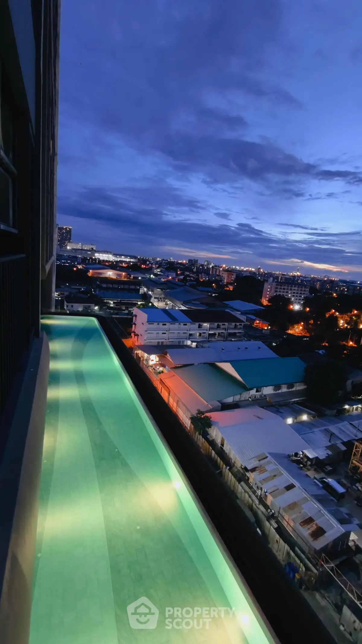 Stunning rooftop pool with panoramic city views at dusk, perfect for luxury urban living.