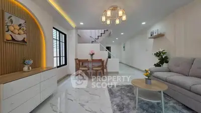 Modern living room with stylish decor and open layout, featuring elegant lighting and contemporary furniture.