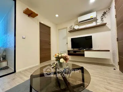 Modern living room with stylish decor and wall-mounted TV in a cozy apartment.