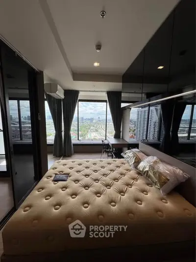 Luxurious bedroom with stunning city view and modern decor in high-rise apartment.