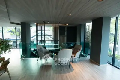 Modern living room with stylish furniture and large windows offering natural light and scenic views.
