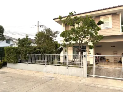 Charming suburban house with lush greenery and spacious driveway