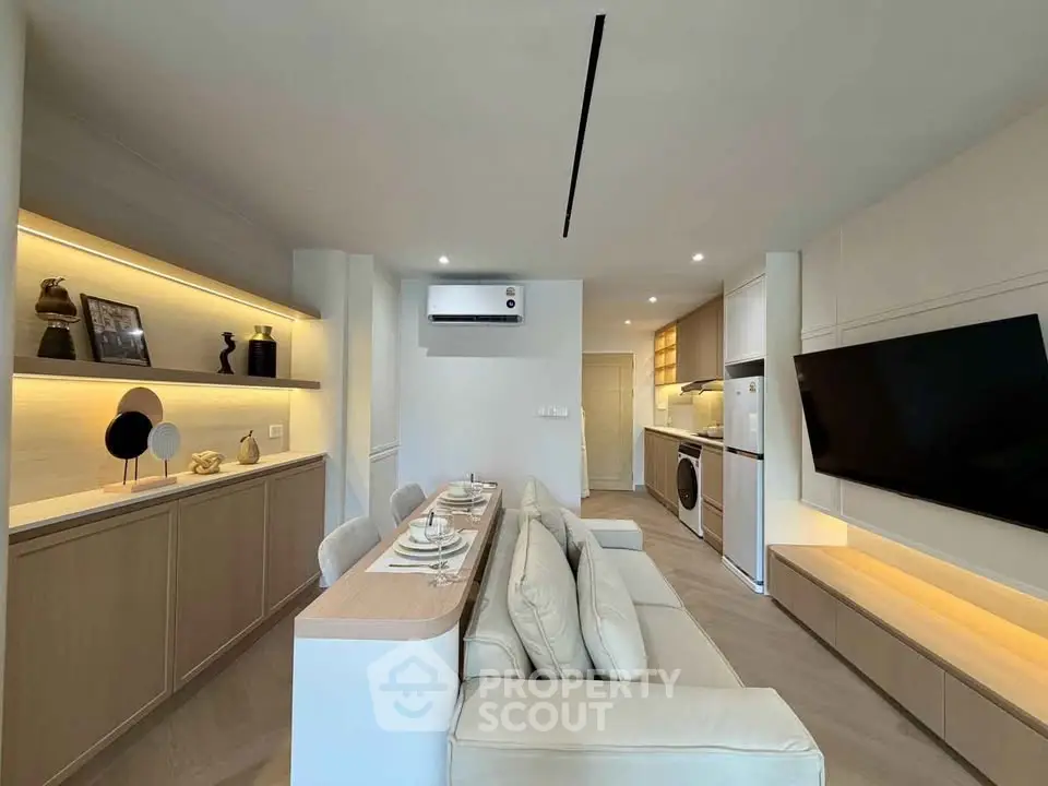 Modern living room with sleek furniture and integrated kitchen appliances