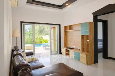 Spacious living room with pool view and modern entertainment unit