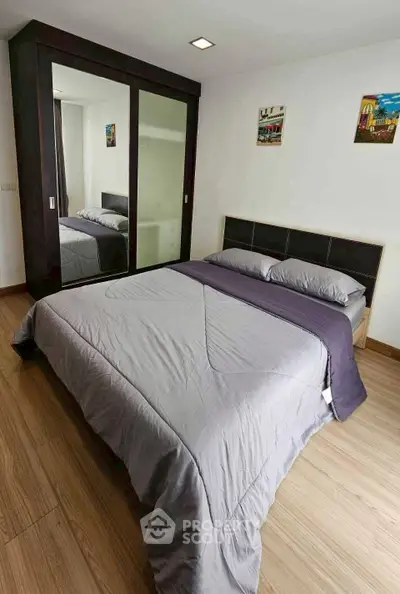 Modern bedroom with sleek design, featuring a comfortable bed and stylish wardrobe, perfect for relaxation.