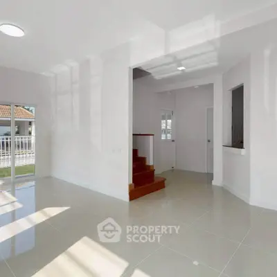 Spacious modern living room with natural light and sleek tile flooring