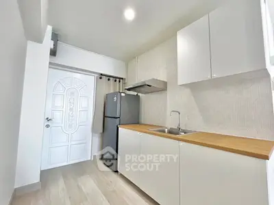 Modern kitchen with sleek cabinets and stainless steel fridge