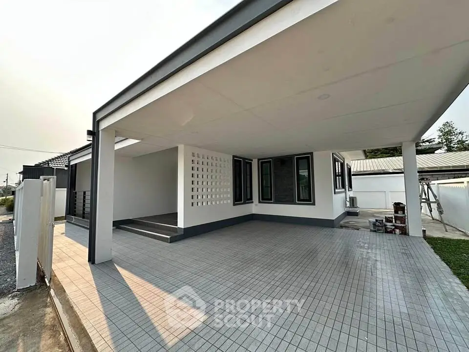 Modern single-story home with spacious carport and sleek exterior design.