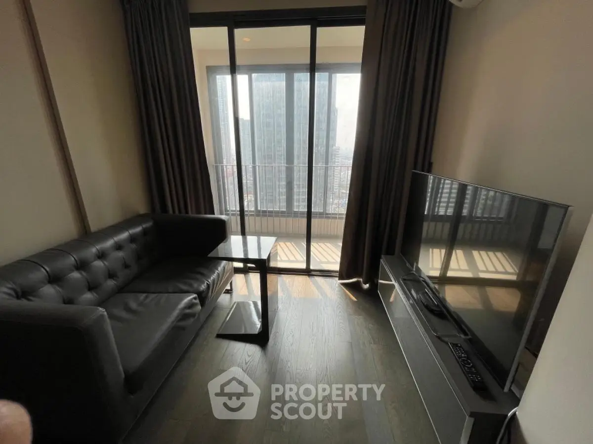 Modern living room with sleek furniture and city view balcony
