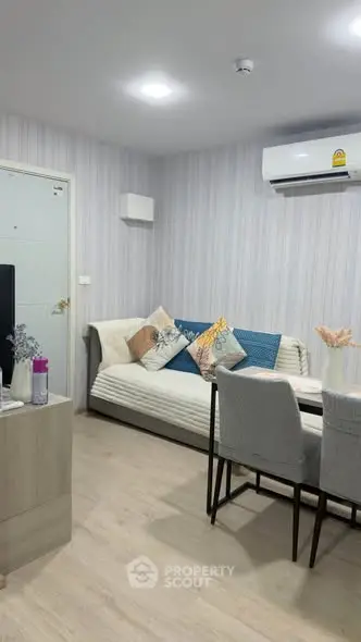Modern living room with stylish decor and air conditioning in a cozy apartment.