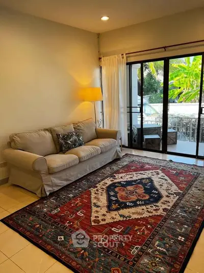 Cozy living room with elegant carpet and balcony view