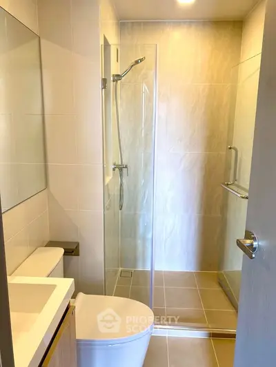 Modern bathroom with sleek shower and contemporary fixtures in a stylish apartment.