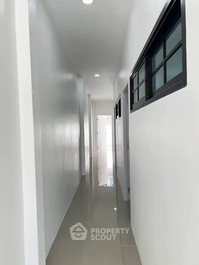 Sleek modern hallway with glossy tiled floor and minimalist design