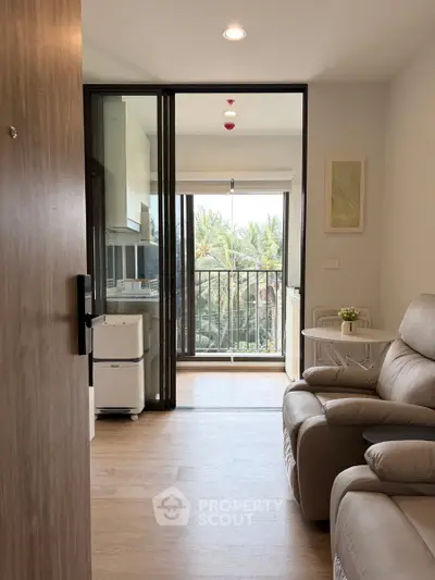Modern living room with balcony view and cozy seating in a stylish apartment.