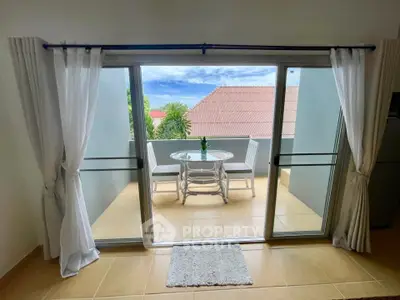 Charming balcony view with outdoor seating and lush greenery, perfect for relaxation and enjoying the scenery.