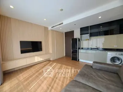 Modern living room with sleek kitchen and cozy sofa in open layout apartment