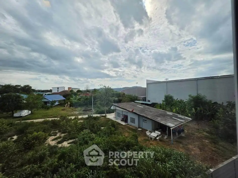 Scenic view of rural property with lush greenery and expansive sky