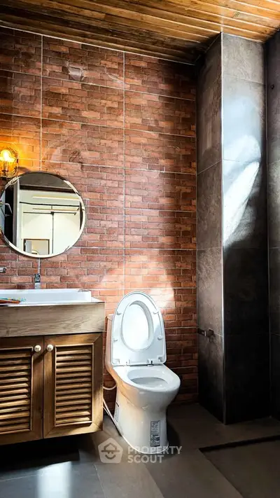 Modern bathroom with brick wall and wooden vanity