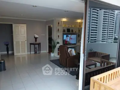 Spacious living room with balcony in modern apartment, featuring stylish decor and city view.