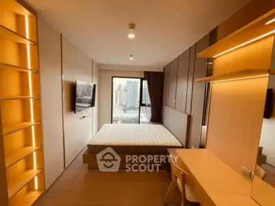 Modern bedroom with city view, featuring built-in shelves and sleek wooden furniture.