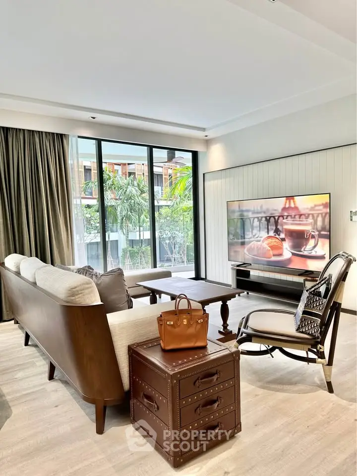 Luxurious living room with elegant furniture and large windows overlooking greenery, perfect for relaxation.