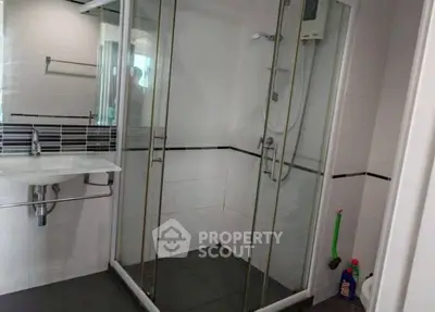 Modern bathroom with glass shower enclosure and sleek fixtures