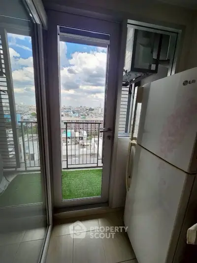 Charming balcony view with cityscape and modern refrigerator, perfect for urban living.