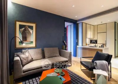Stylish modern living room with open kitchen, sleek furniture, and elegant decor in a contemporary apartment.