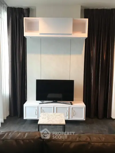 Modern living room with sleek TV unit and elegant curtains