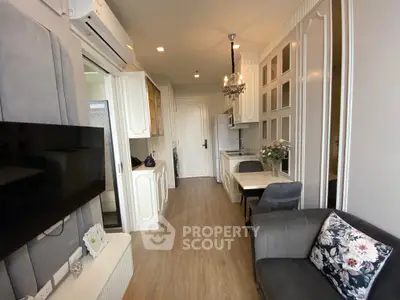 Chic modern apartment interior with elegant decor and open kitchen layout.