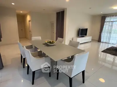 Spacious modern dining area with sleek table and chairs, perfect for entertaining.