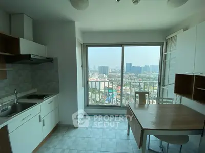 Modern kitchen with city view from high-rise apartment