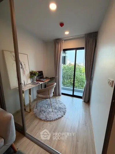 Chic study room with balcony view, modern decor, and natural light in a stylish apartment.