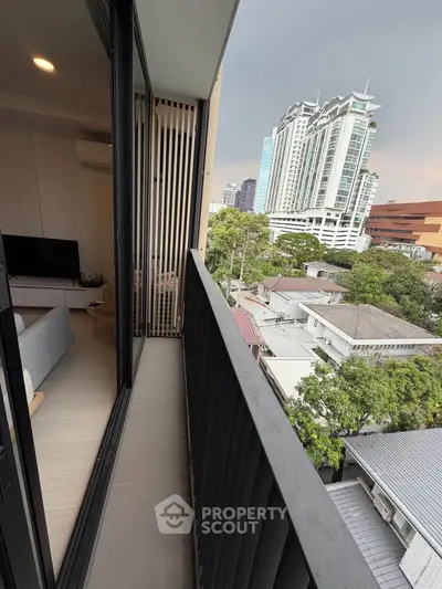 Modern balcony with city view, adjacent to stylish living room in urban apartment
