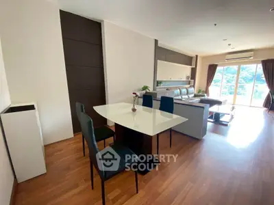 Spacious modern living room with elegant dining area and large windows for natural light.