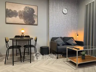 Stylish modern living room with cozy sofa, elegant dining area, and chic decor.