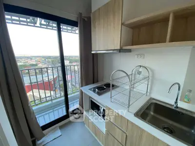 Modern kitchen with balcony view in high-rise apartment